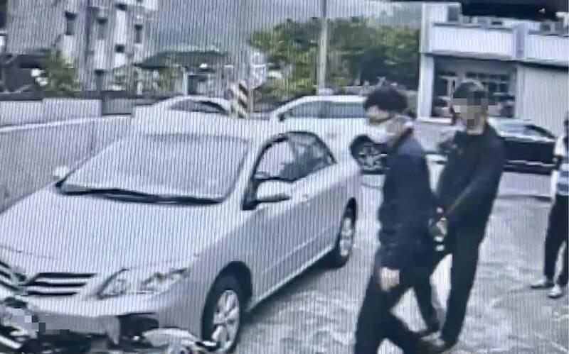 51岁黄姓男子（右后方）杀人后留在现场，警方到场准备押解上车。（民众提供）