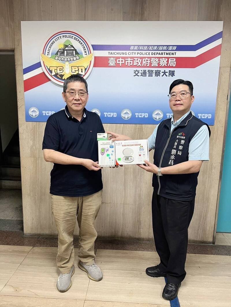 张姓商人（左）送血压机、额温机与血氧机到台中市警局保安大队。（民众提供）
