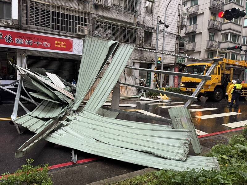 新北市板桥区长江路下午发生顶楼加盖铁皮掉落砸到车辆事故。（黄淑君提供）