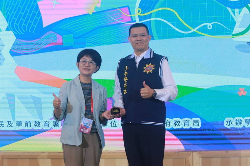 新北市警察局少年警察队队长廖睿辰（右）接受表扬。（记者吴仁捷翻摄）